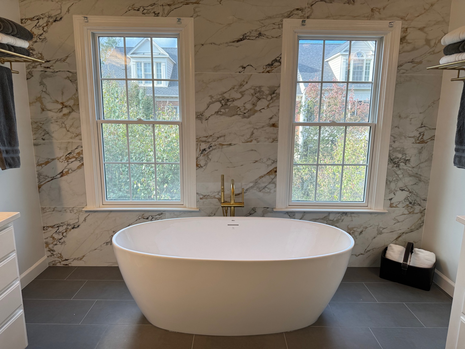 Freestanding tub under large windows